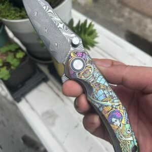 Dark vg10 Damascus steel folding knife with titanium handle, exquisitely engraved